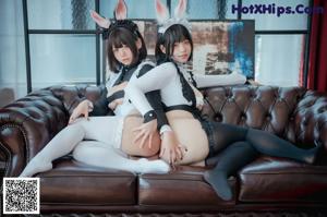 A couple of women dressed in bunny costumes posing for a picture.