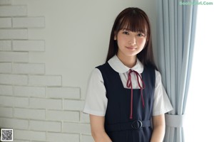 A woman in a white shirt and white stockings posing for a picture.