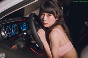 A woman sitting in the back seat of a car.