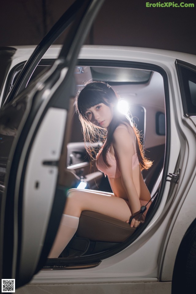 A woman sitting in the driver's seat of a car.