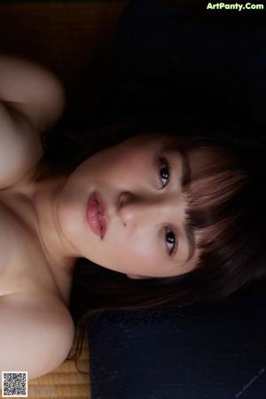 A woman in lingerie laying on a couch. 