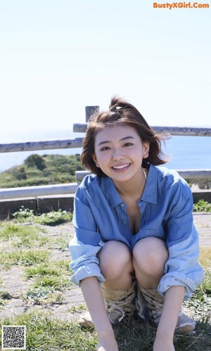 A woman in a yellow bikini posing for a picture.