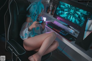 A woman with blue hair playing a video game.