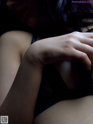 A woman in lingerie leaning against a window.