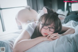 A woman wearing glasses and a cat ears outfit.