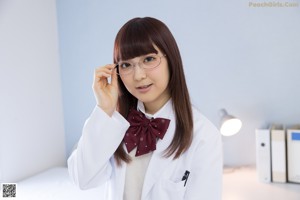 A woman in a school uniform sitting on a chair.