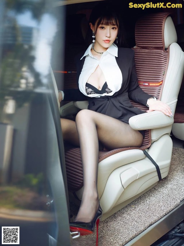 A woman sitting in the back seat of a car.